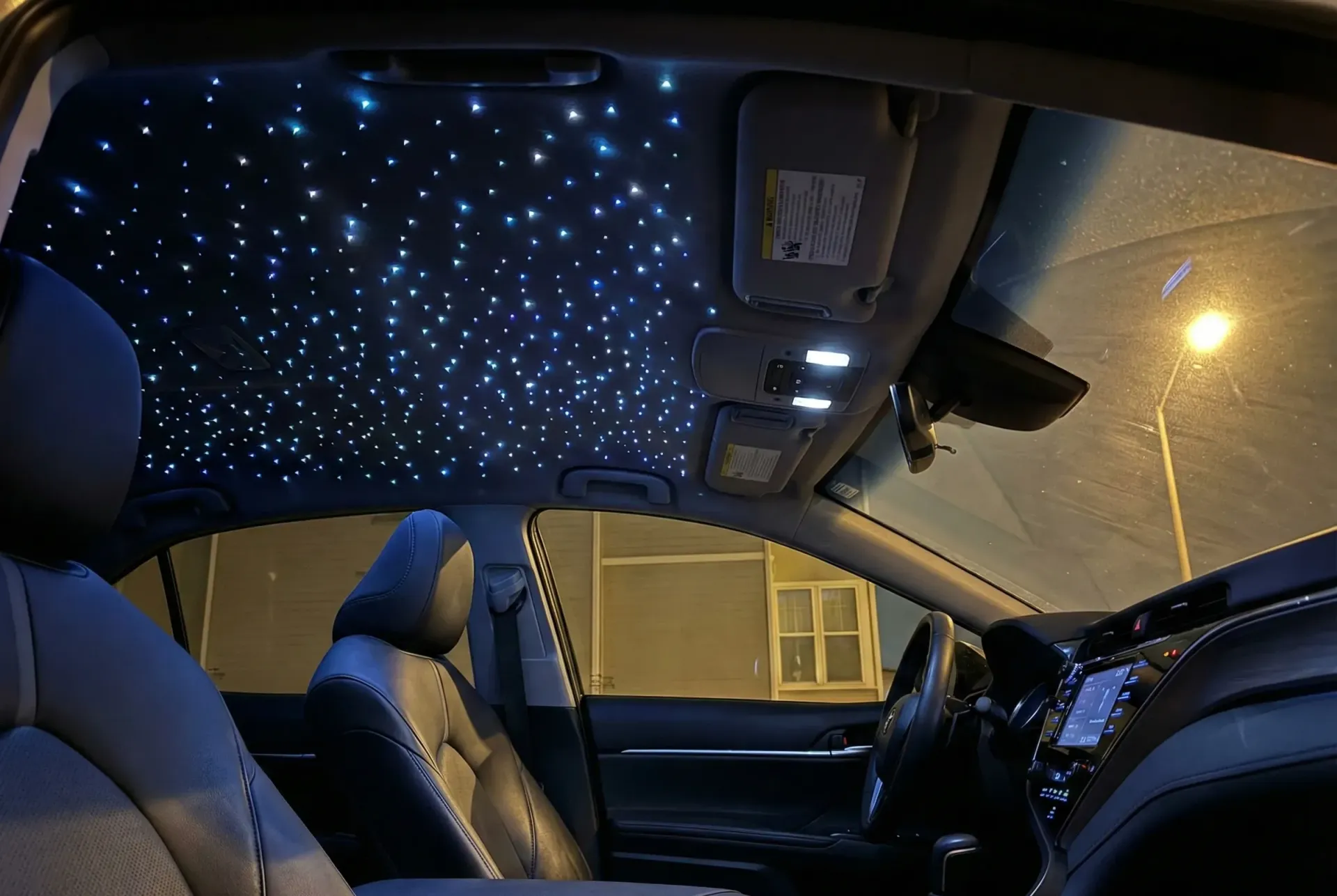 Toyota Camry interior with a starlight headliner of blue and white fiber-optic stars, installed in Bryan, TX